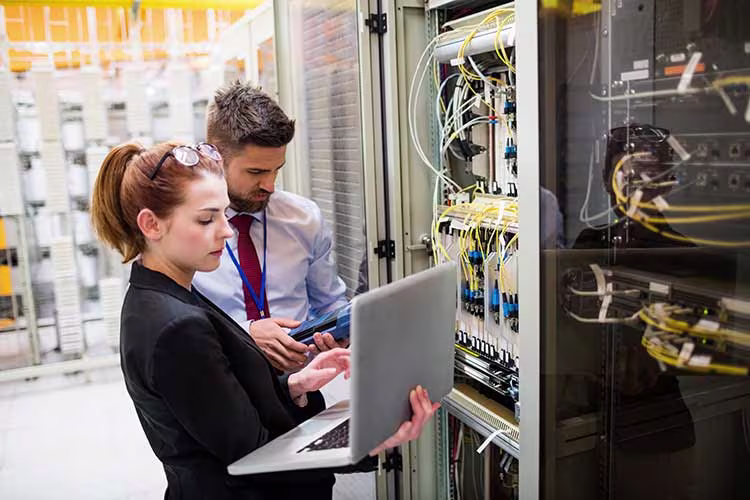 Two technicians in front of a server rack